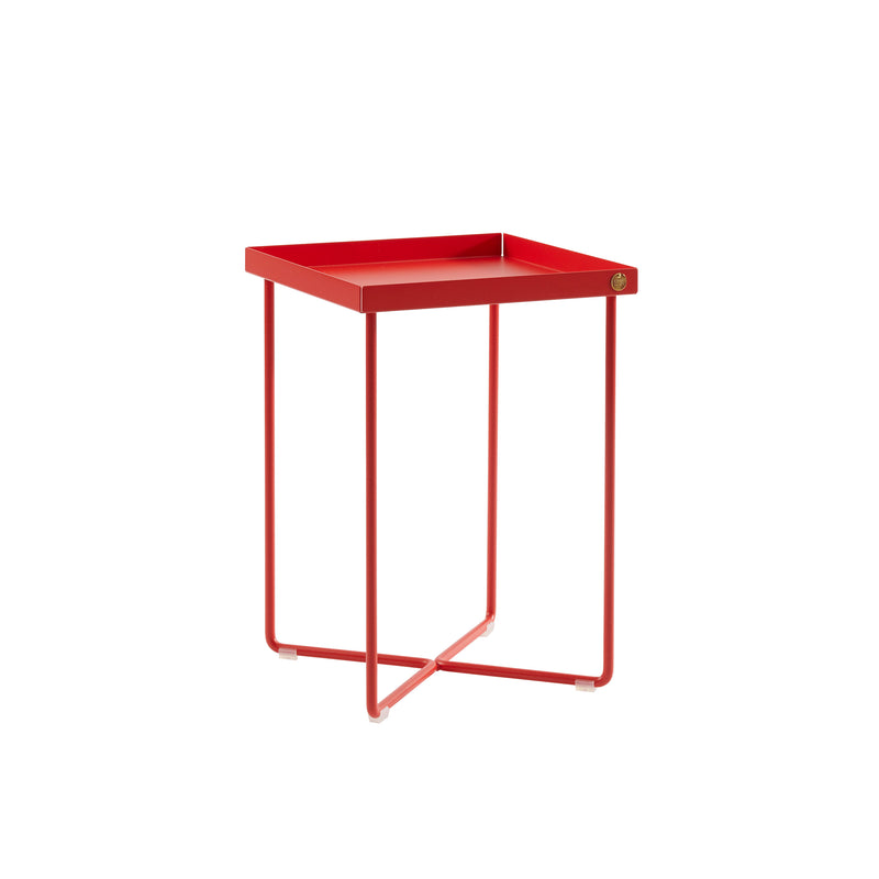 The POI MINI Side Table by Victor Foxtrot is a modern red bedside table with a minimalist design, featuring a square top supported by four slim legs intersecting at the base for stability.