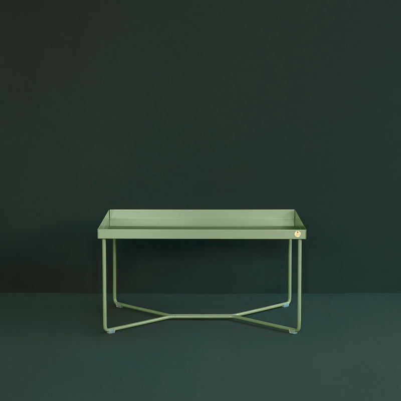 The POI SINGLE Side Table by Victor Foxtrot is a minimalist rectangular design with thin powder-coated steel legs set against a dark green background, showcasing clean lines and uniform color.
