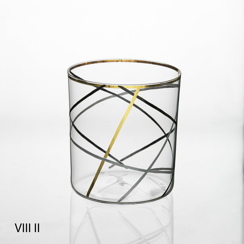 The Neo Light VIII Enamel Collection by Lobmeyr features a transparent glass with elegant gold and black crisscrossing lines, a gold rim, and Roman numerals VIII II in the bottom left. Designed by Martino Gamper, its a contemporary ornament against a plain white background.