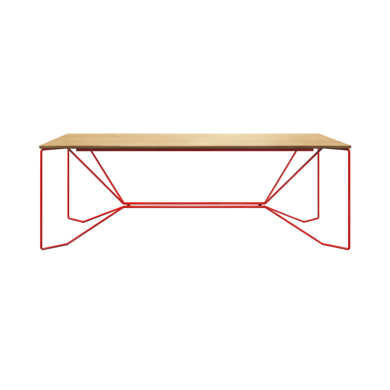 The SAME SAME Oak Table by Victor Foxtrot is a minimalist dining table with a solid oak top and geometric red powder-coated steel legs. Its angular, open-frame design contrasts natural wood with vibrant red metal, offering a modern, sleek look.