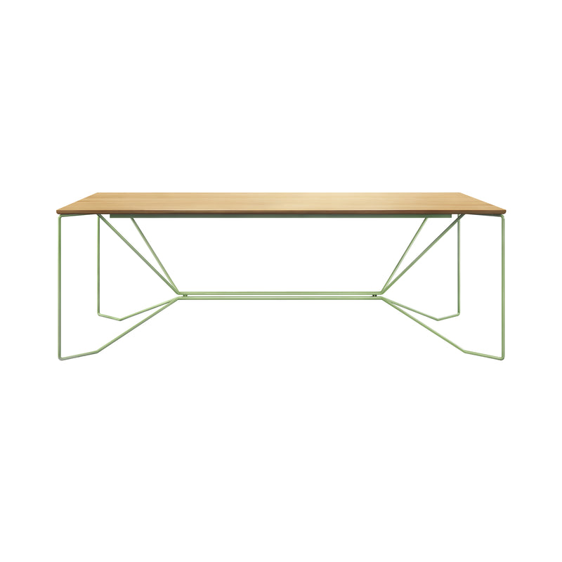 The Victor Foxtrot SAME SAME Oak Table features a solid oak top with geometric light green powder-coated steel legs. The intricate leg patterns create a modern, airy look, making it stand out beautifully against a plain white background.