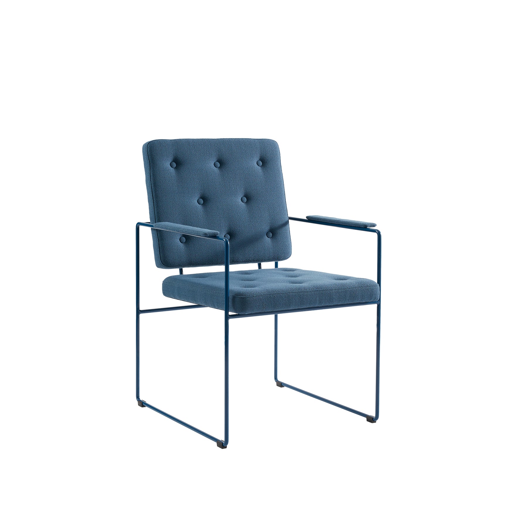 The SWELL TIME Dining Chair by Victor Foxtrot combines a sleek steel frame with a tufted blue cushion featuring button stitching on the square back and seat, complete with armrests, offering a perfect blend of minimalist style and comfort.