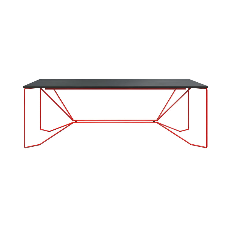 The SAME SAME Linoleum Table by Victor Foxtrot is a modern dining table featuring a black rectangular top on a red powder-coated steel geometric frame with angled lines and zigzag supports.