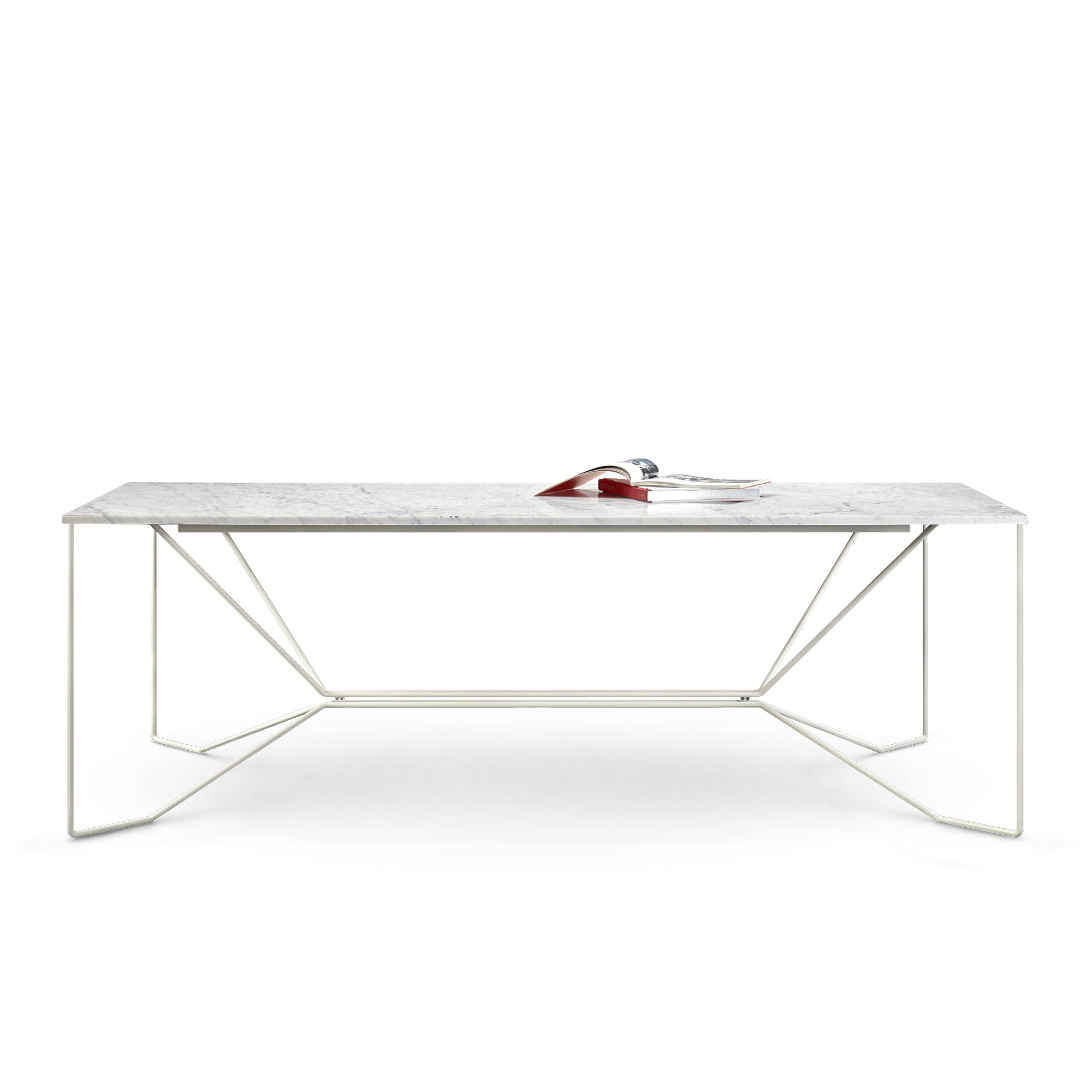 A sleek modern piece, the Victor Foxtrot SAME SAME Marble Table features a rectangular Carrara Venatino marble top and geometric white powder-coated steel legs. A magazine is open at its center, highlighted against a plain white background that accentuates the minimalist design.
