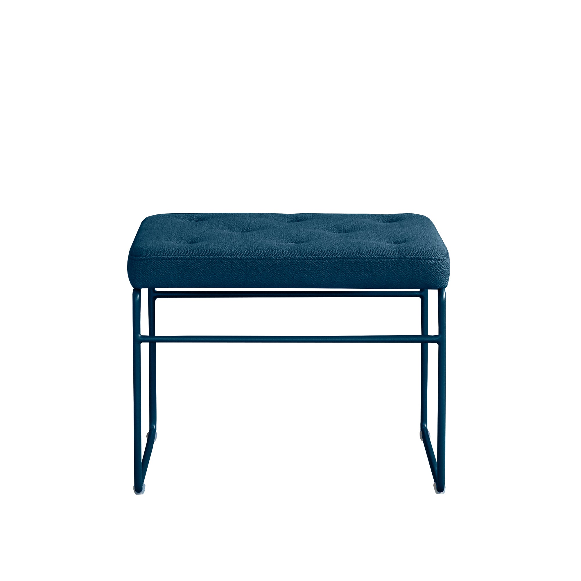 The SWELL TIME Ottoman by Victor Foxtrot is a modern rectangular stool with blue upholstery, cushioned top, and button stitching. It has a minimalist steel frame with straight legs and is displayed against a white background.