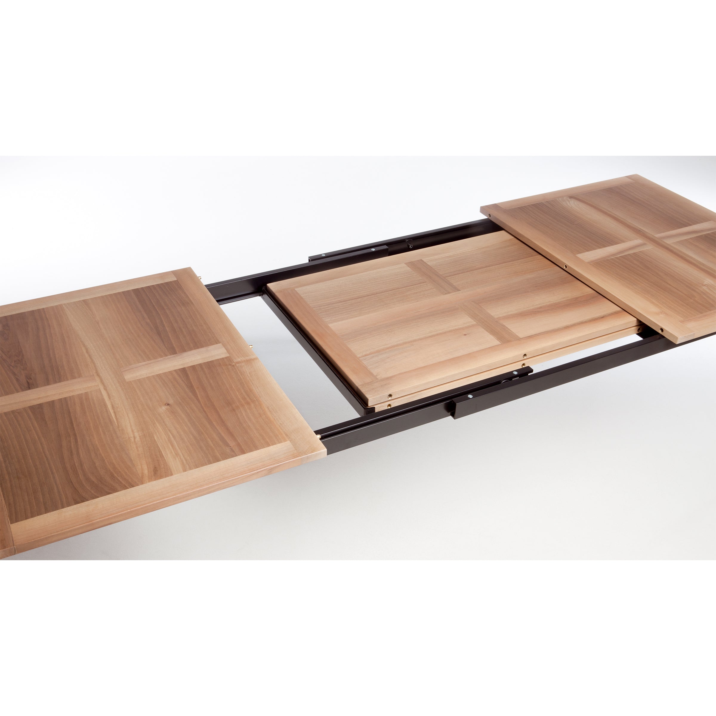 The UPW 1010 Extendable Table by WB Form exemplifies superior craftsmanship with a visible sliding mechanism. Partially extended, it reveals a central leaf panel for extra seating. Its light brown finish and smooth surface enhance the sturdy construction and elegant design.