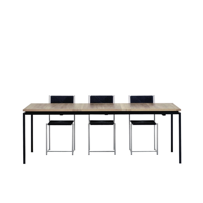 The UPW 1010 Extendable Table by WB Form is a modern dining set showcasing superior craftsmanship, featuring a rectangular wooden table with a black metal frame and four matching black chairs with metal legs, symmetrically arranged on a white background.