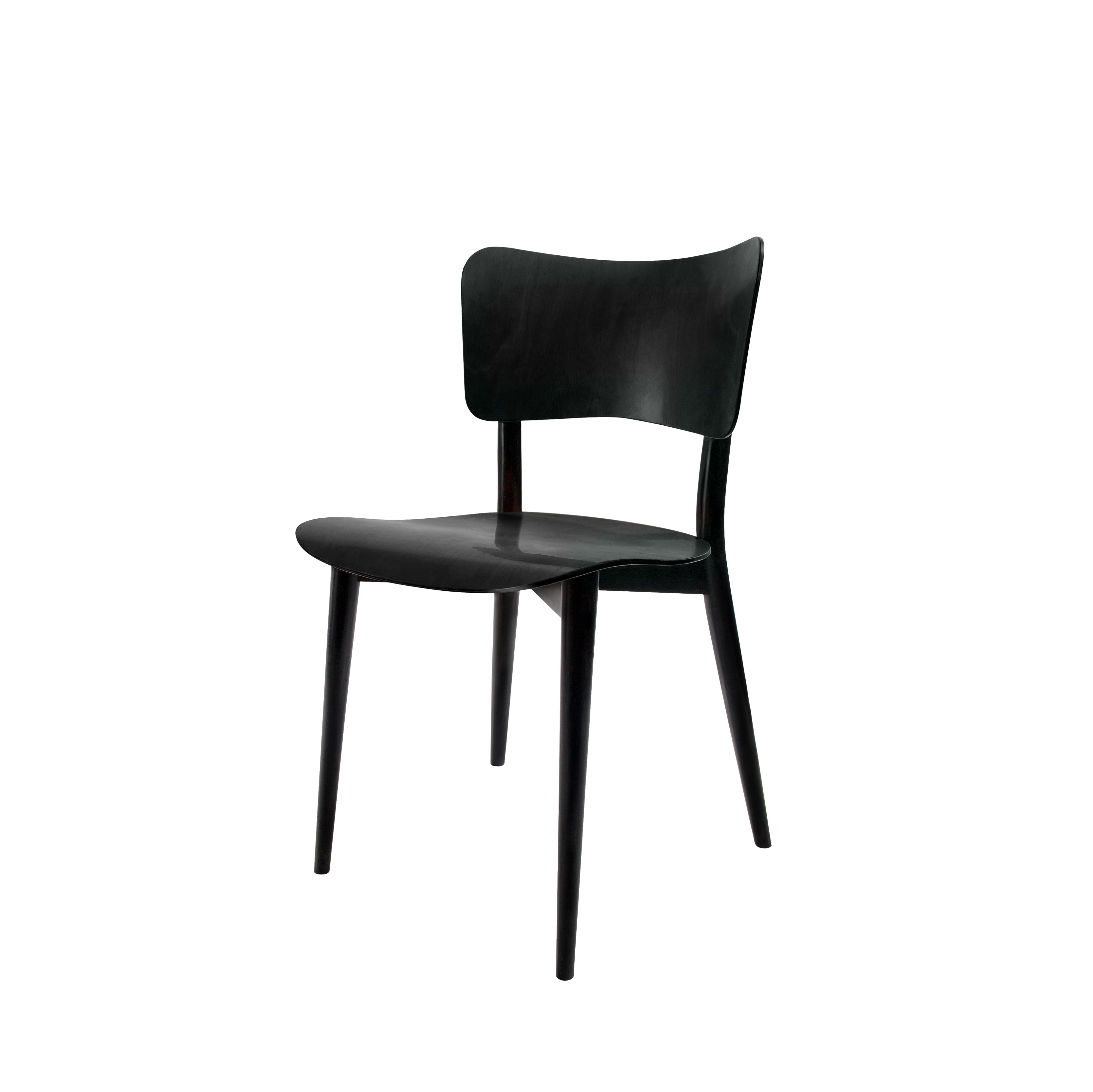 A sleek, modern black WB Form Kreuzzargenstuhl Chair with a smooth wooden finish, featuring a gently curved backrest and seat supported by four slender, tapered legs.