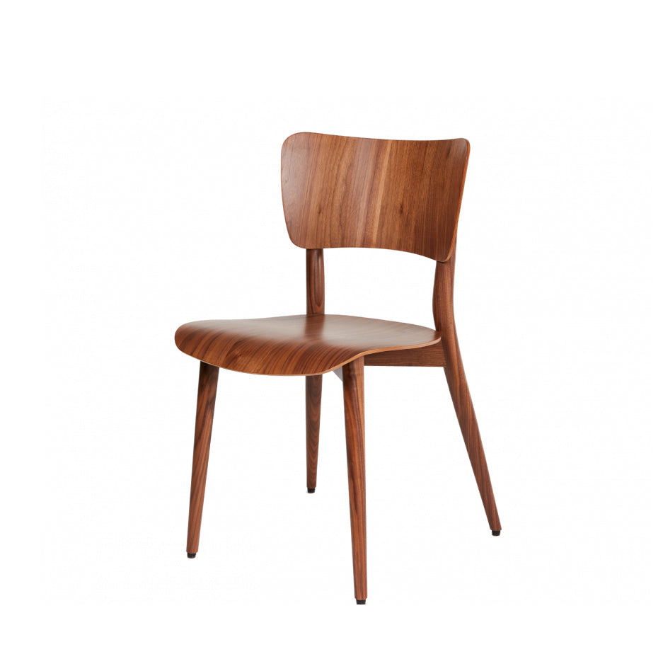 The Kreuzzargenstuhl Chair by WB Form is a modern wooden piece featuring a smooth, curved backrest and seat on four tapered legs. It showcases a rich wood finish that highlights the natural grain, all set against a plain white background.