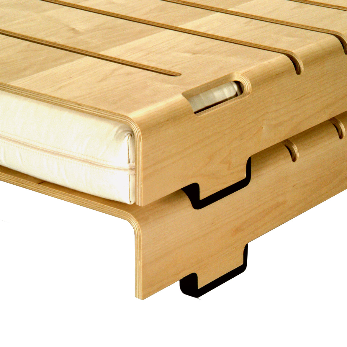 The WB Form Turtle Stacking Bed is a modern wooden bed frame featuring a minimalist plywood shell with smooth, light-colored wood. It has cut-out handles and slots, and a slatted base for the mattress, offering flexible solutions for contemporary spaces.