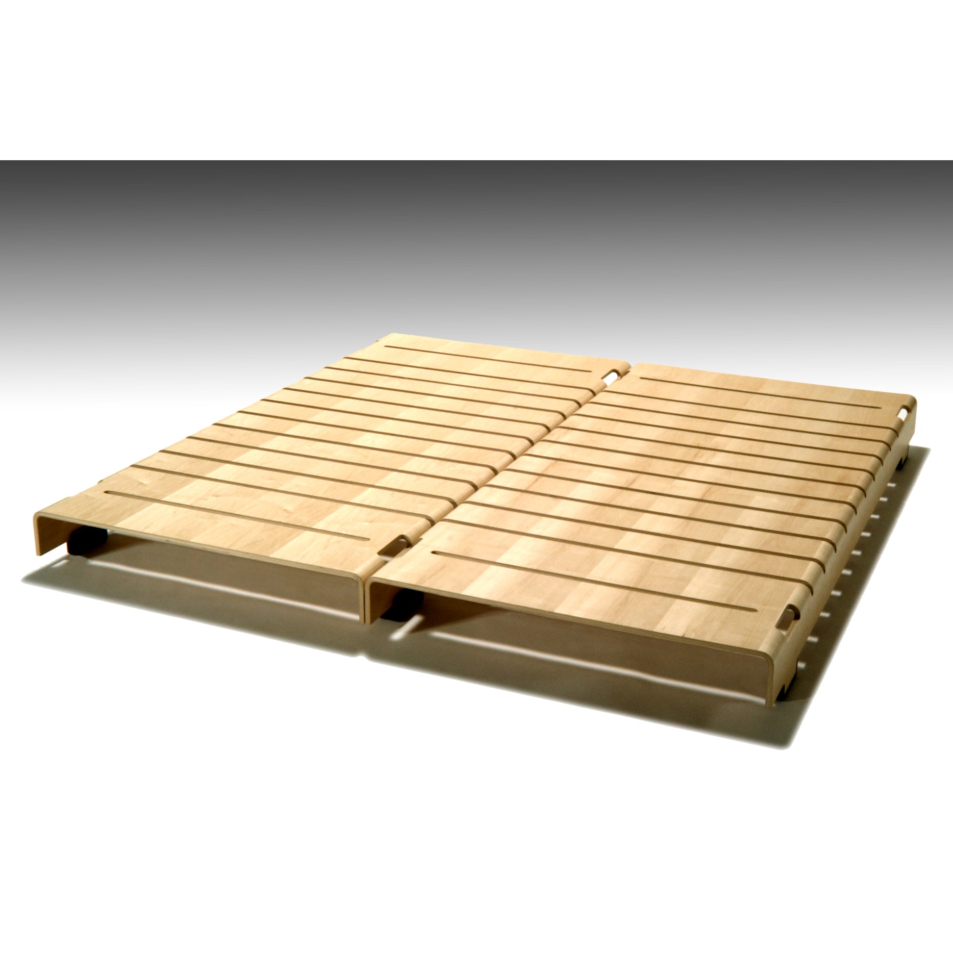 The Turtle Stacking Bed by WB Form features wooden slats in a light finish, arranged parallel with slight gaps to support a mattress. Its design, resting on a neutral gradient background, offers a modern and stackable appeal.