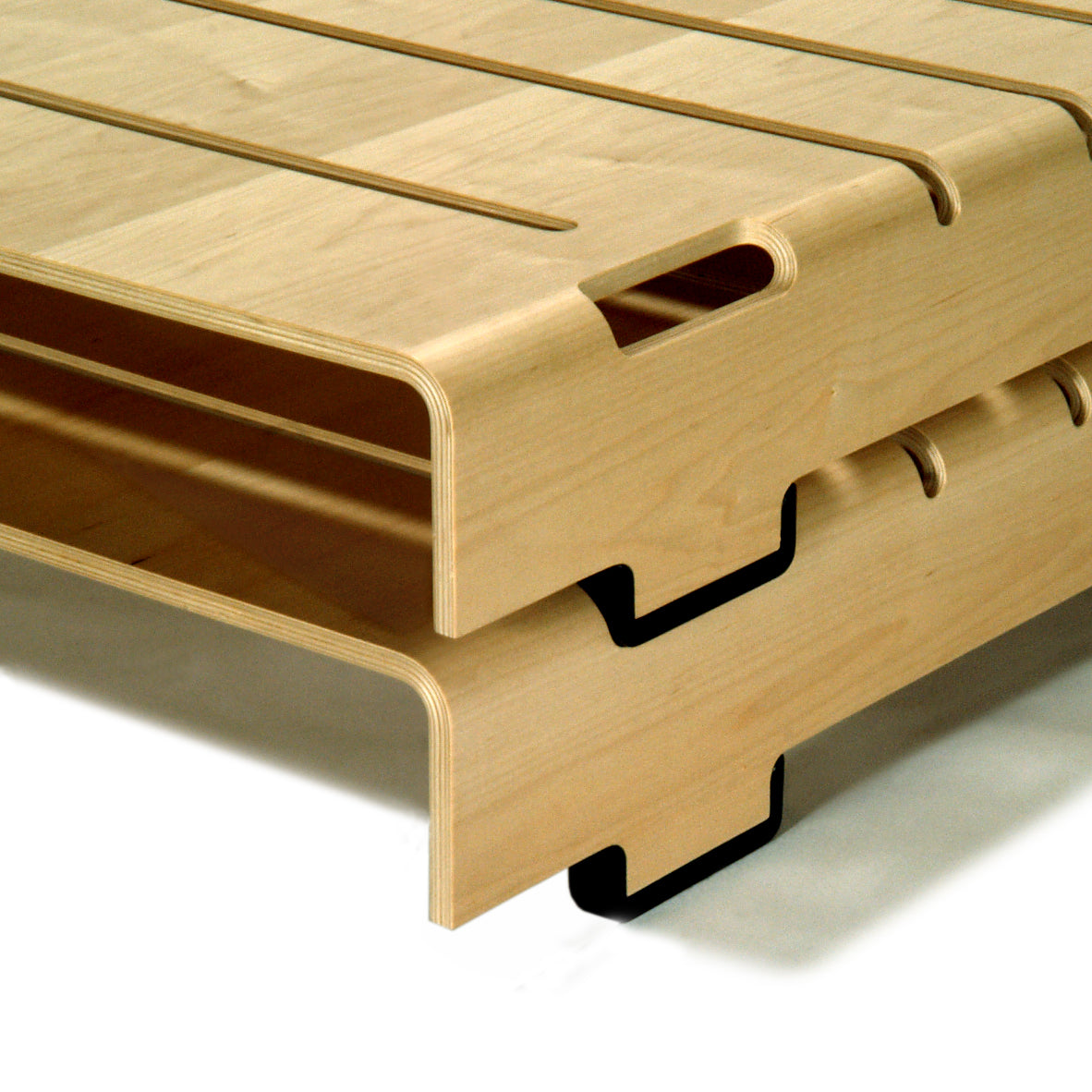 Close-up view of the WB Form Turtle Stacking Bed, highlighting its minimalist design with smooth, curved edges and slotted layers. The stackable beds feature a light wood finish and visible black metal brackets, showcasing their flexible furniture design.