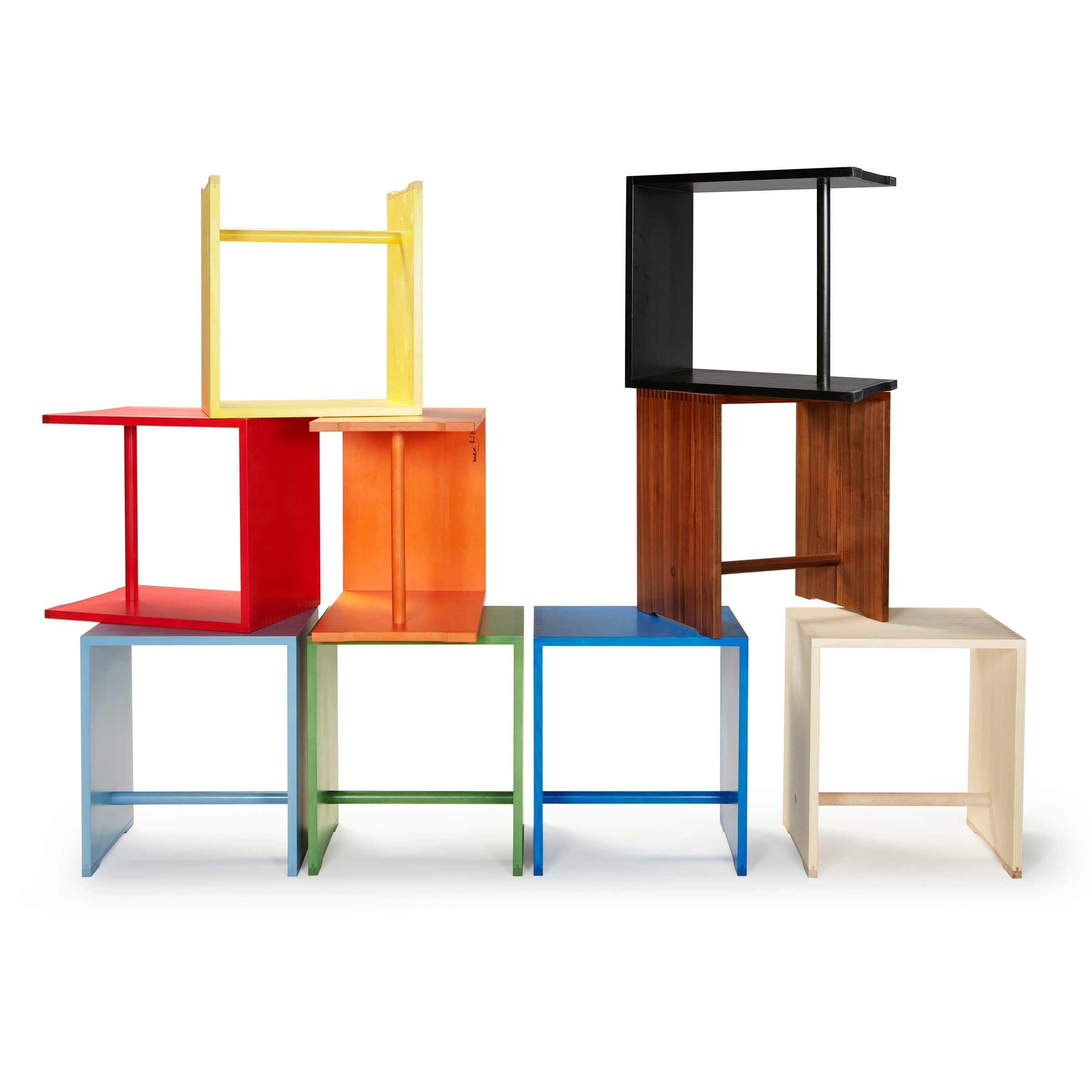The Ulmer Stool by WB Form features a modern, minimalist design with geometric stacking, reminiscent of the Max Bill Ulm Stool. Available in nine finishes and vibrant shades of red, blue, yellow, green, black, and white against a white background.