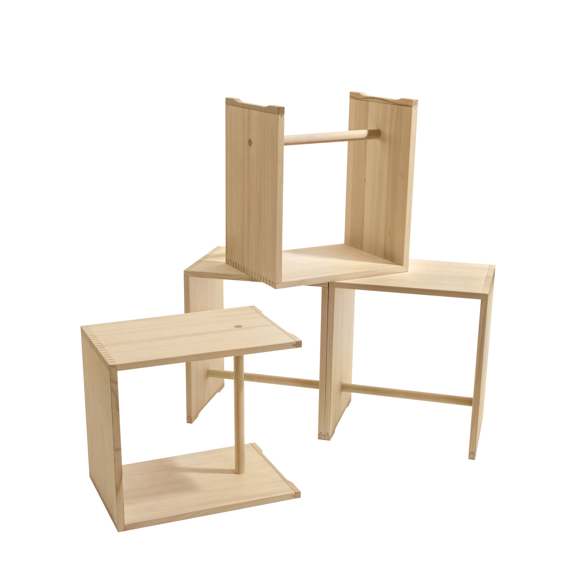 Three WB Form Ulmer Stools display a clean, geometric design in a natural wood finish. One stands upright, while the others are angled. Available in nine finishes, these versatile stools enhance their simple rectangular look.