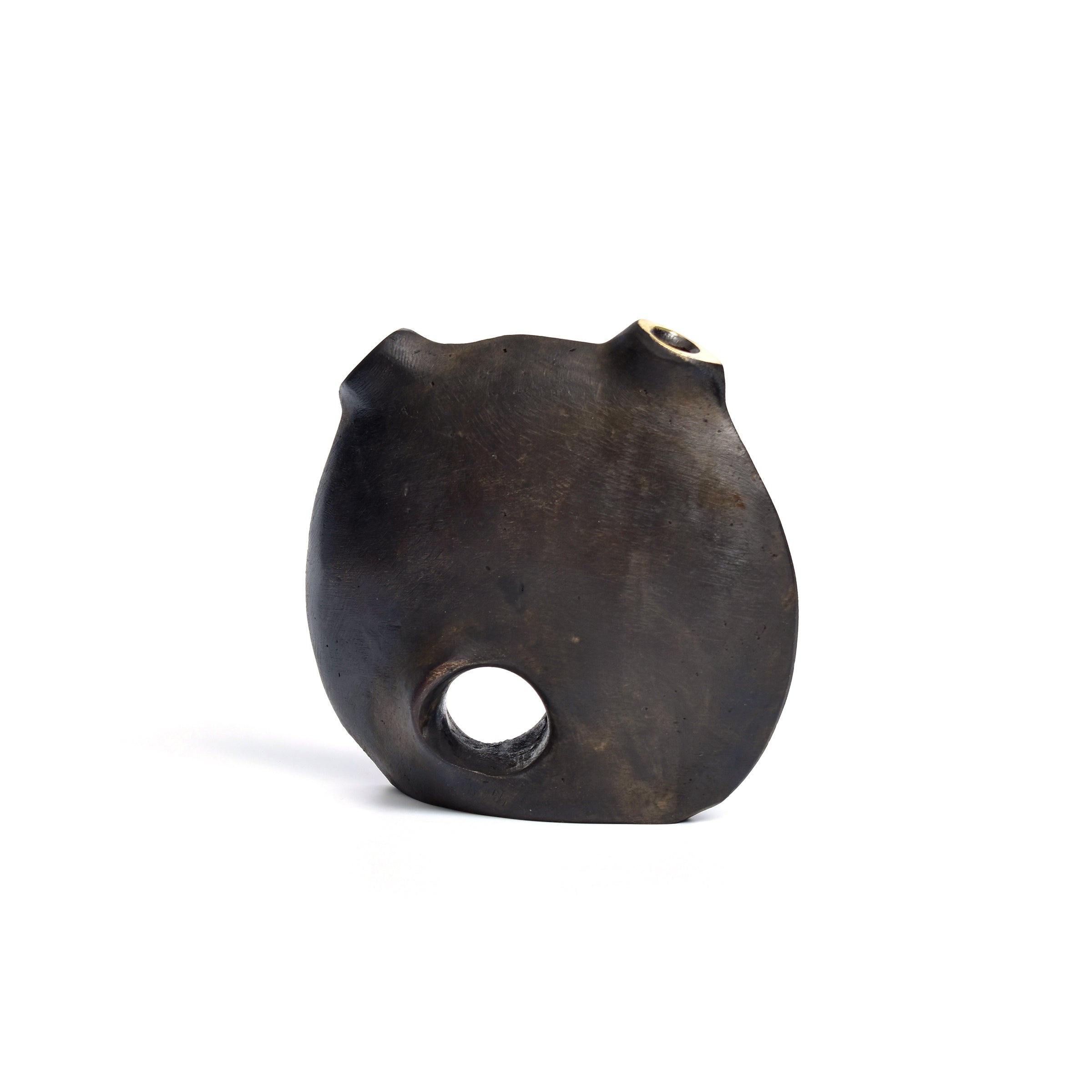 The Vase Moon #3789 by Werkstätte Carl Auböck features a sleek black round design with a distinctive circular hole at the base and subtle protrusions on top, accented by a polished surface that gently reflects light.