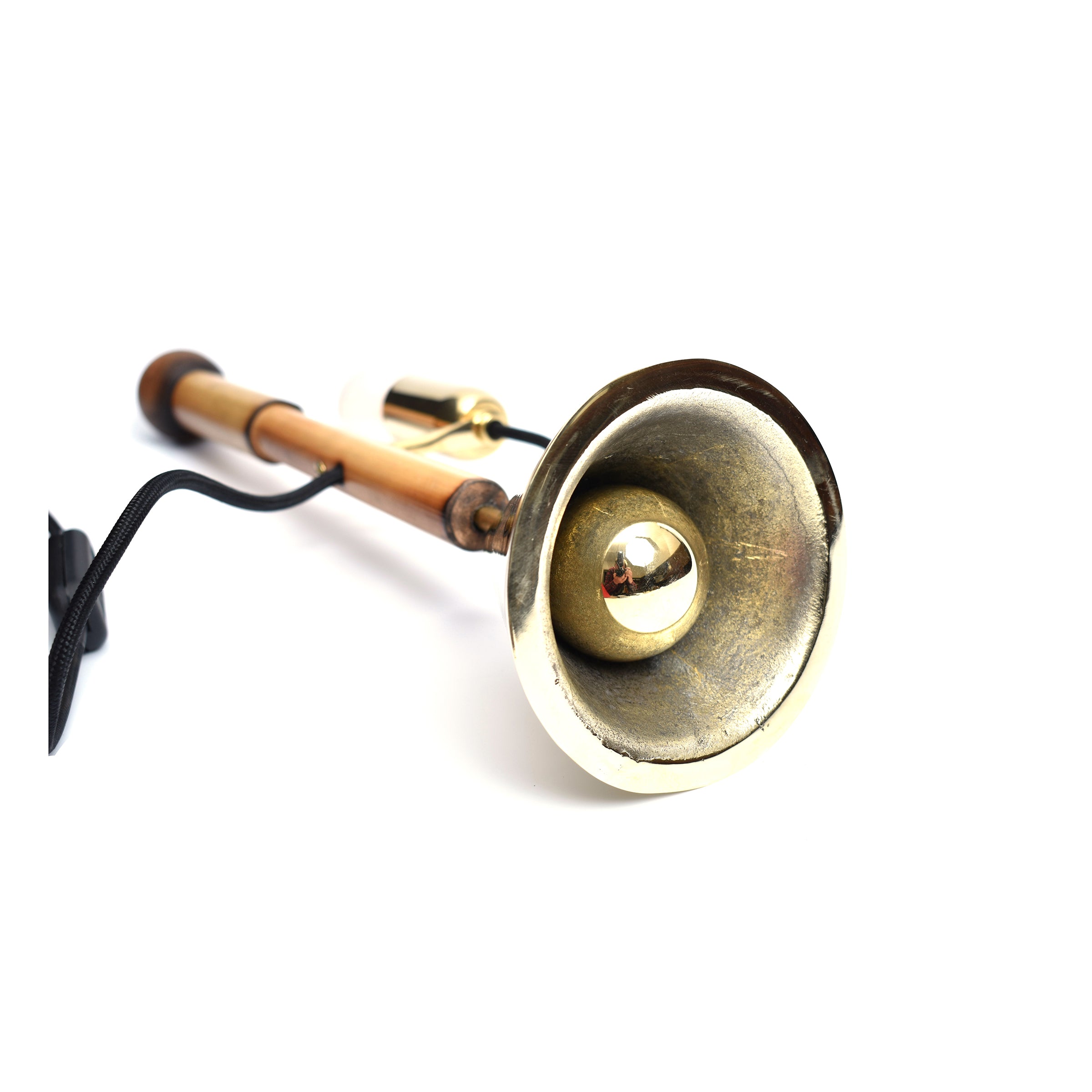 The Table Lamp Bell #3875 by Werkstätte Carl Auböck features a copper and brass design on a white background, reminiscent of an elegant Viennese townhouse. Its shiny brass bell is showcased prominently with a black cord attached.