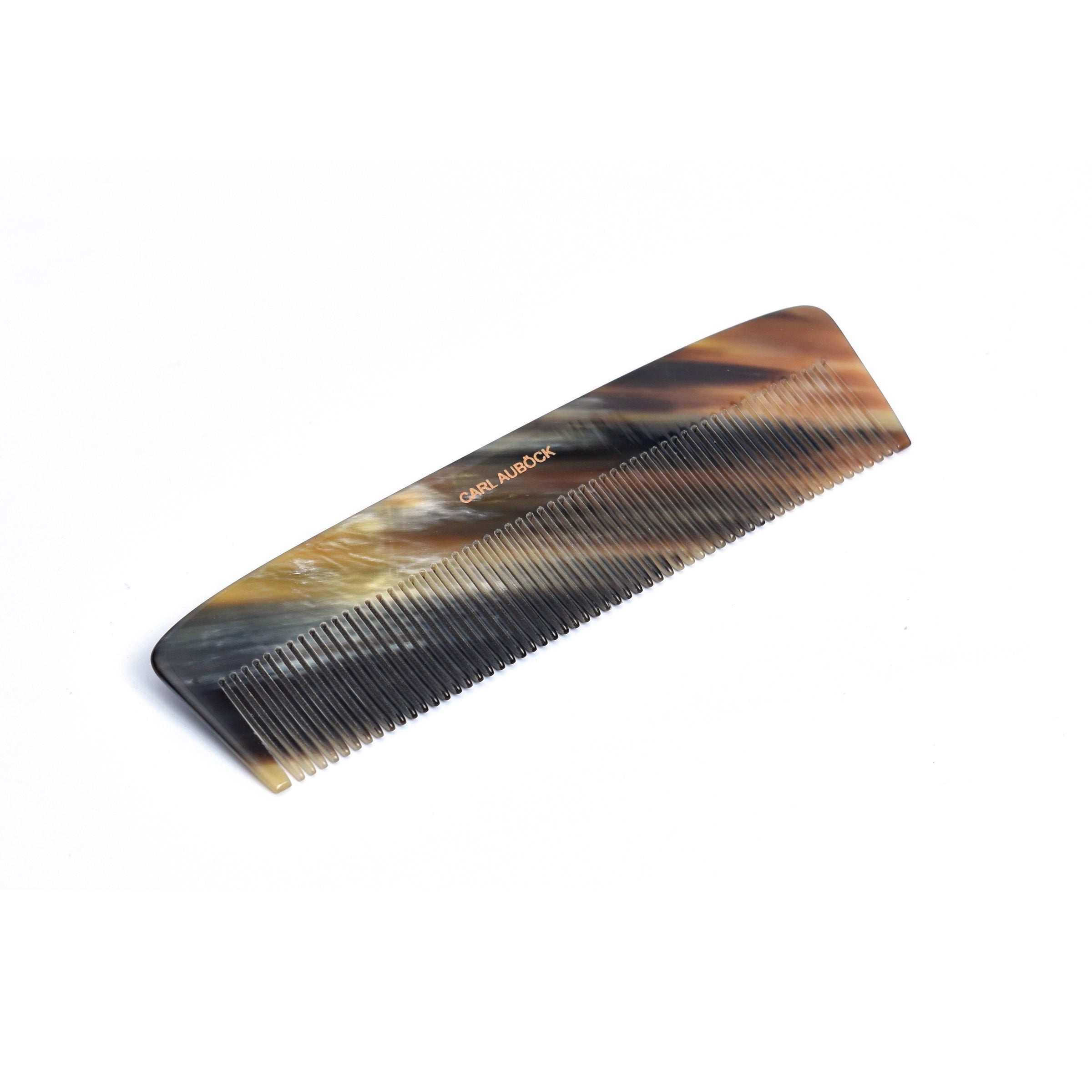 A close-up of the Horn Comb Gents #5233 by Werkstätte Carl Auböck reveals its fine teeth and smooth, polished brown surface. Elegantly displayed in the OMM Collection, the comb is positioned diagonally on a simple white background.