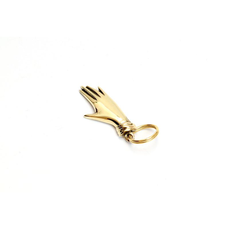 The Keyring Hand #5734 by Werkstätte Carl Auböck features a distinctive brass design in a hand shape with elongated fingers, attached to a circular keyring against a plain white background.