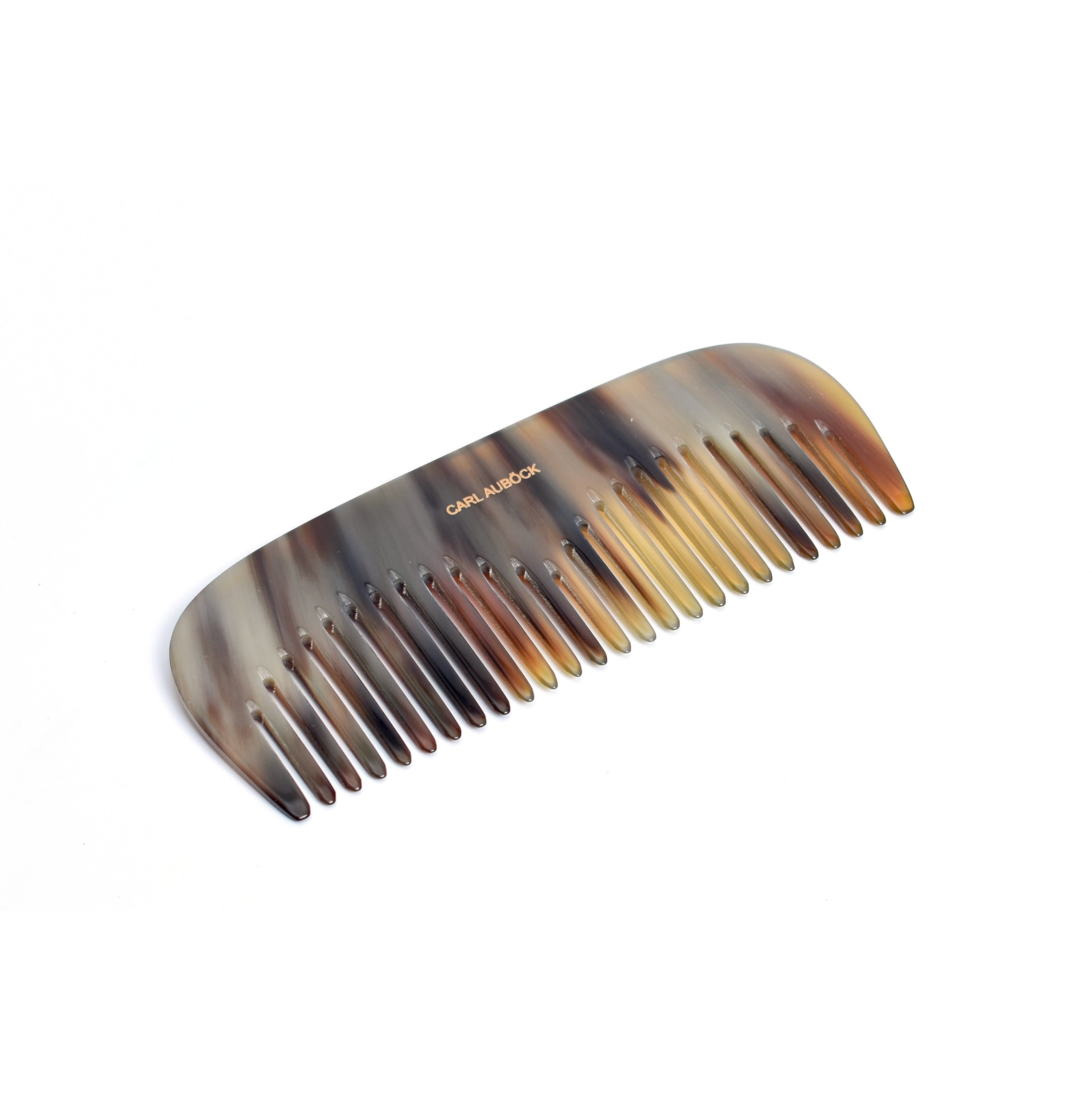 The Horn Comb Ladies #7084 by Werkstätte Carl Auböck showcases a tortoiseshell pattern with blended brown and beige shades. Its smooth, curved edge and evenly spaced wide teeth are perfect for gentle hair detangling.