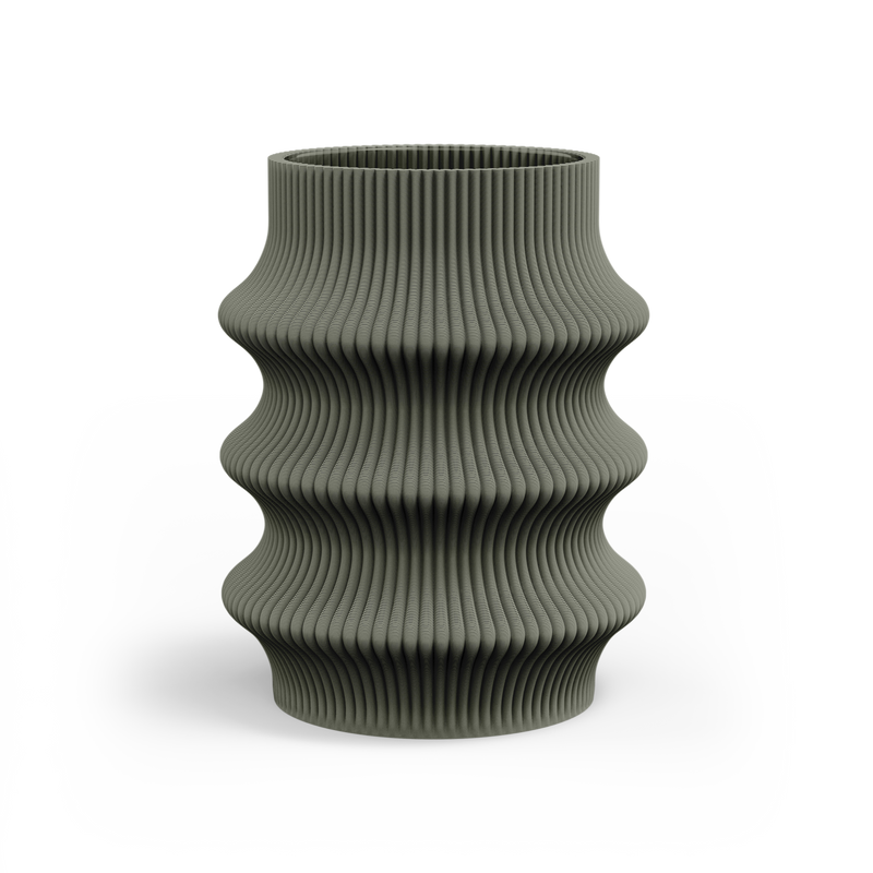 The Zayl 129g Vase by Sheyn stands against a white background, featuring a green ribbed ceramic design with wavy curves. Its 3D-printed texture and unique silhouette highlight a modern aesthetic and cutting-edge digital design.