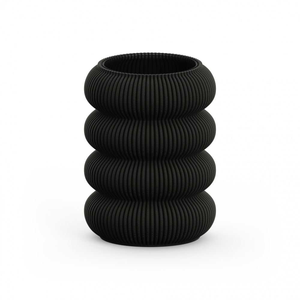 The Zayl 130g Vase by Sheyn is a black, cylindrical piece with a textured, ribbed design similar to architectural pillars. It features four stacked, rounded segments and is showcased against a plain white background.