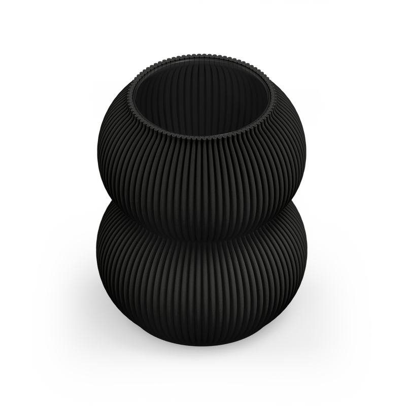 The Zayl 159g Vase by Sheyn is a matte black, ribbed, double-sphered creation made from recyclable materials. Set against a light gray background, its unique texture and symmetry exude a contemporary and artistic flair, perfectly blending modern design with eco-friendly innovation.