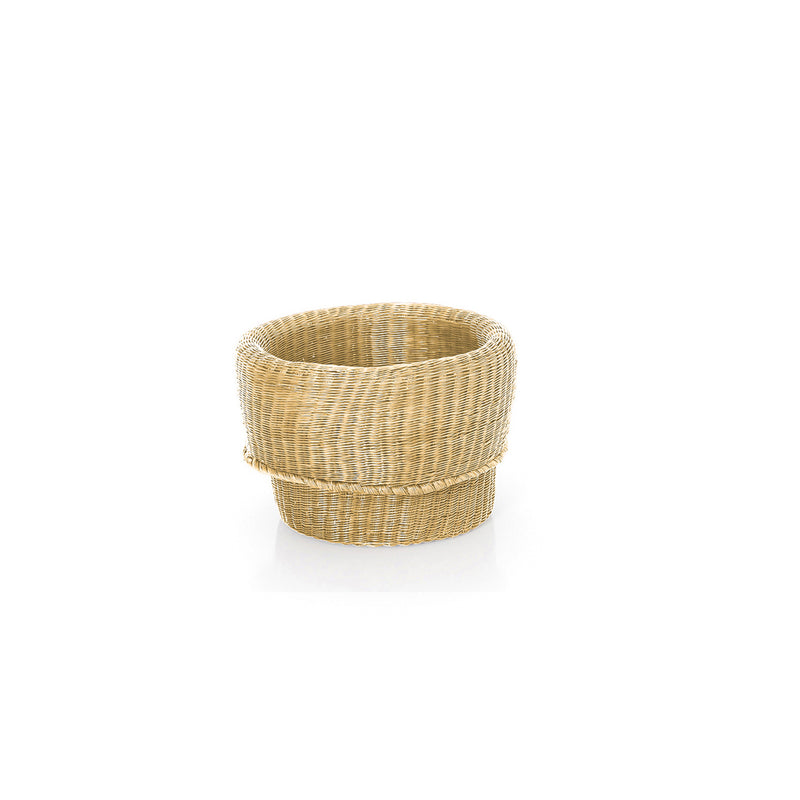 The Ames Fibra Basket by Ames is a round, woven wicker basket handcrafted in Colombia, featuring a thick rim and natural light brown color, shown on a plain white background.