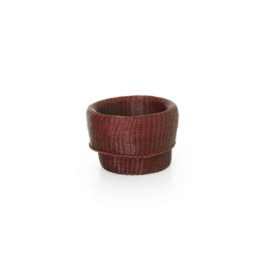 The Ames Fibra Basket by Ames is a round, dark brown woven wicker basket handcrafted in Colombia with a slightly flared top, shown against a plain white background.
