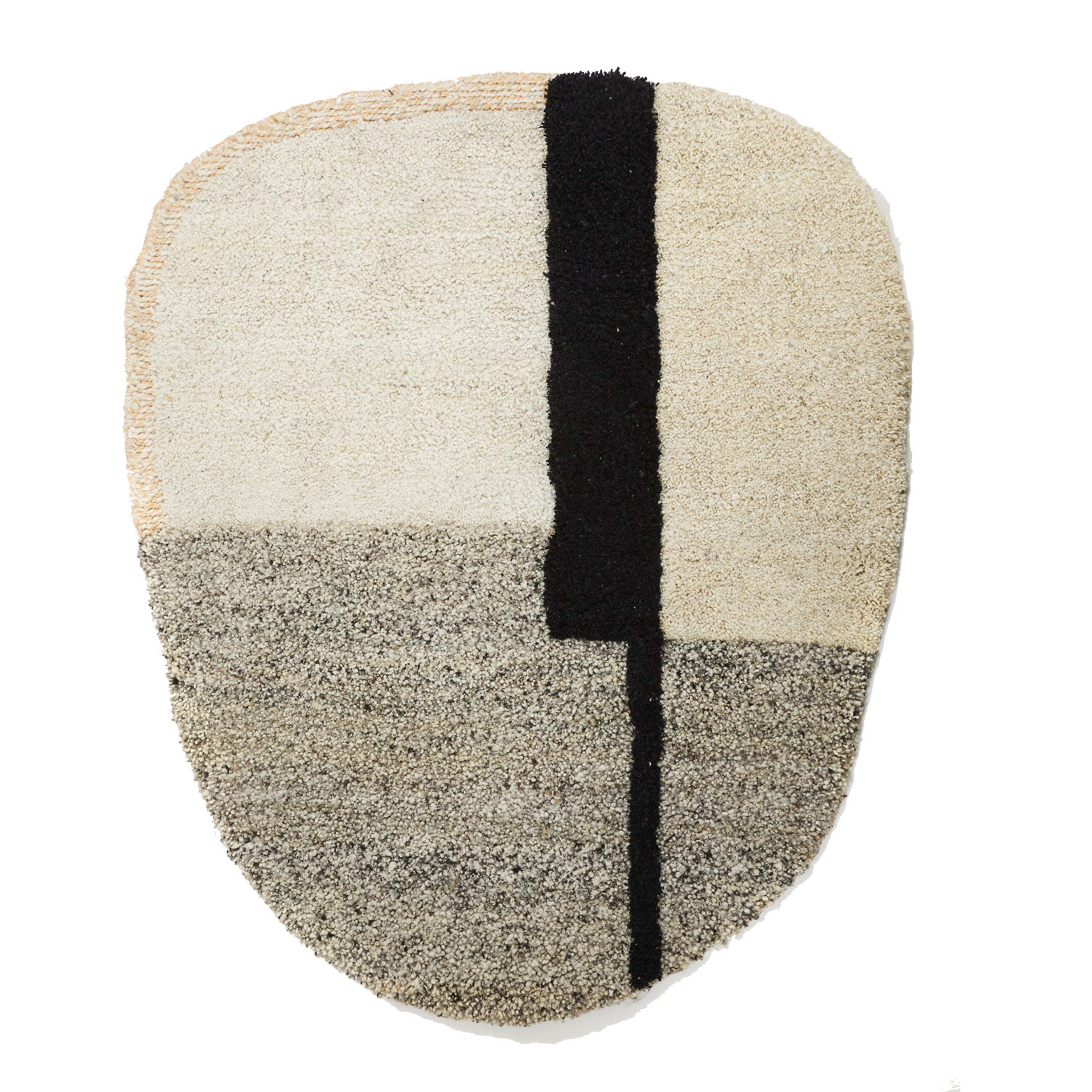 The Ames Nudo Rug is an abstract piece with an irregular oval shape and a neutral palette. It features four textured sections in beige, cream, and gray, divided by a bold black line, inspired by Colombian arts and crafts.