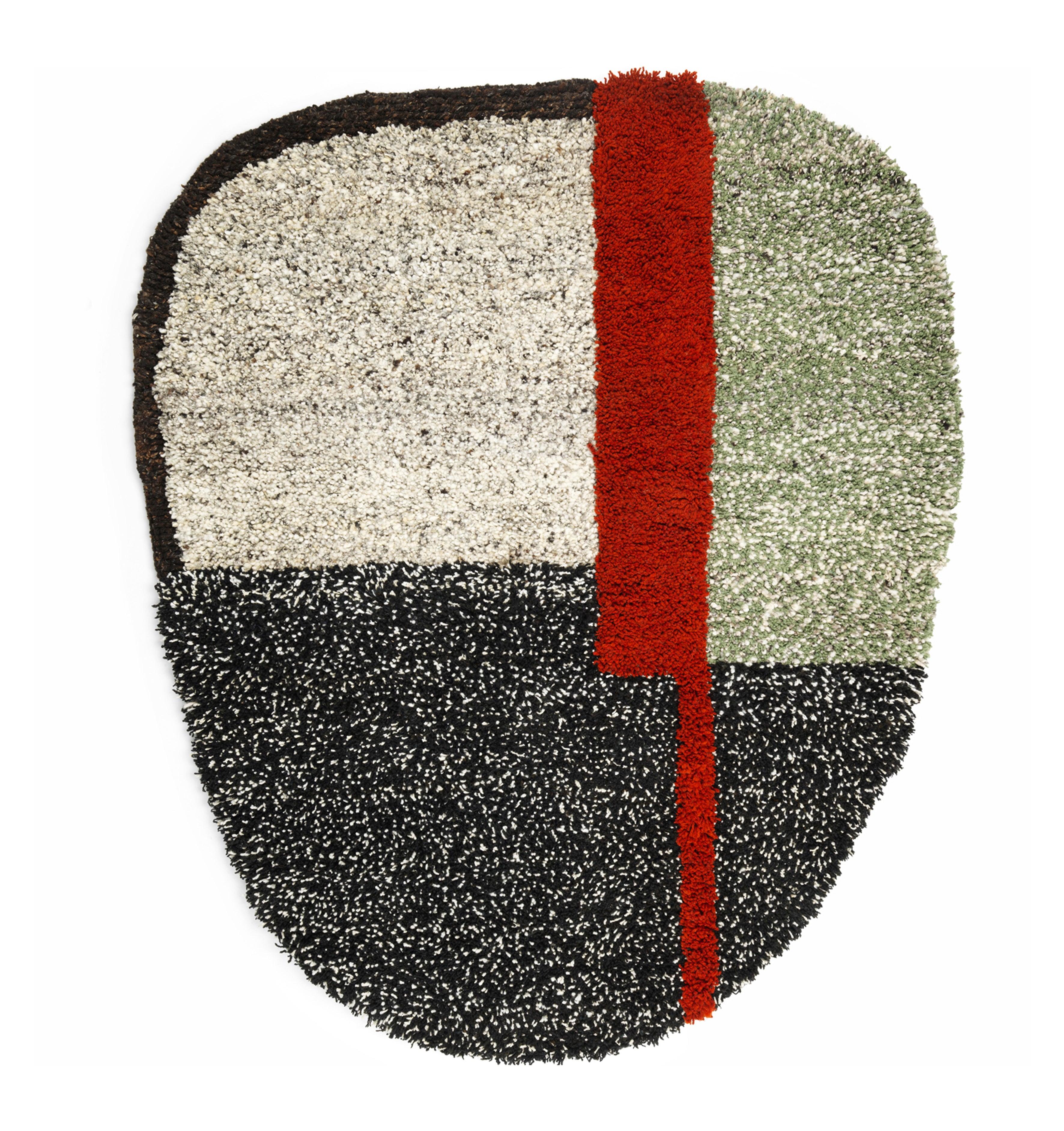 Explore Colombian craftsmanship with Ames Nudo Rug, featuring an abstract textured design. It includes quadrants in black, white, gray, and green tones accented by a bold vertical red stripe slightly off-center for a modern artistic flair.