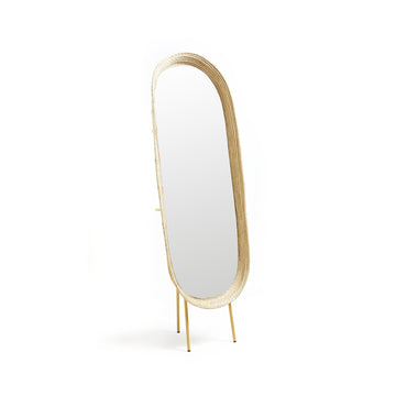 The Ames Killa Standing Mirror by Ames features an oval, full-length design with a light iraca palm woven frame and sleek gold legs, displayed against a plain white background.
