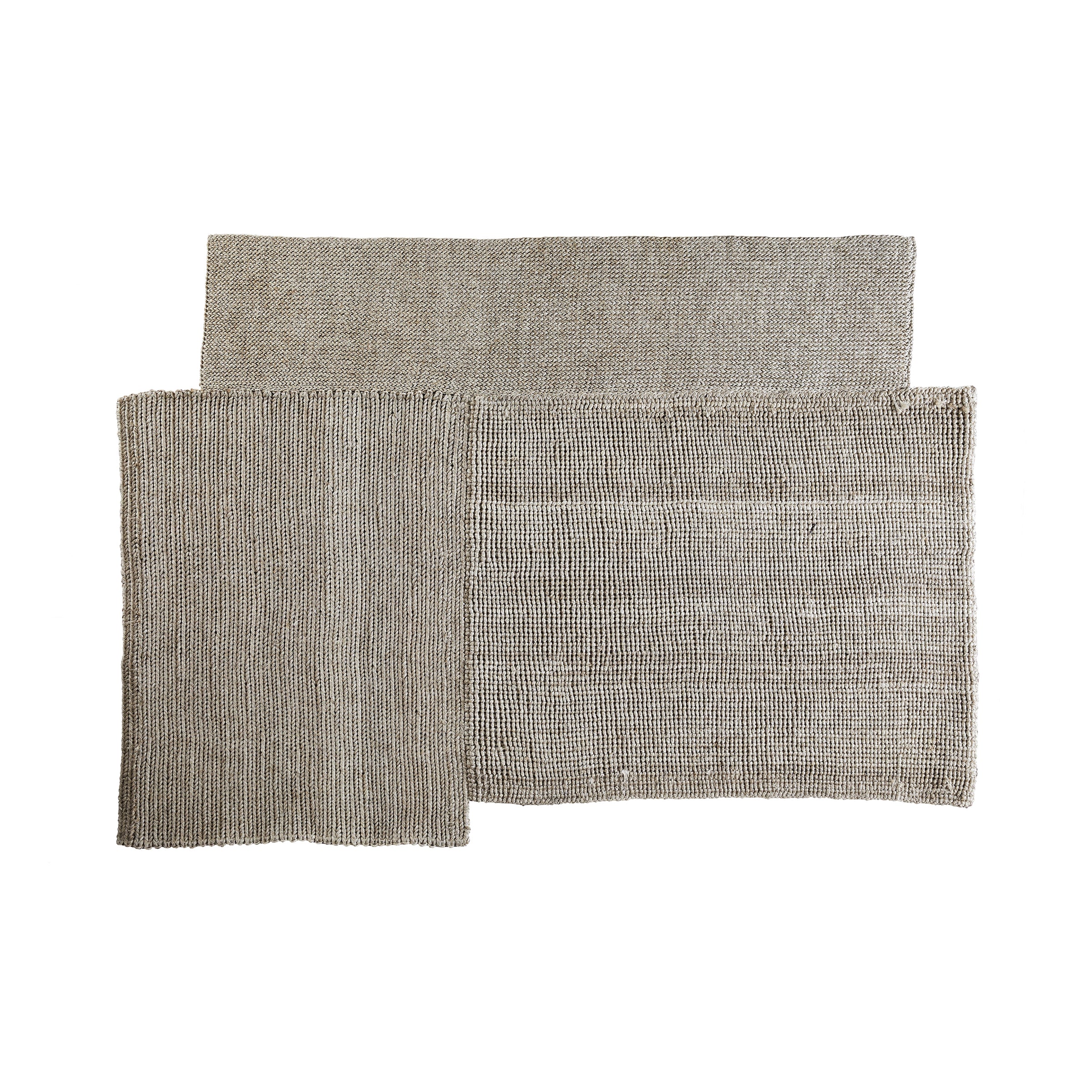 The Cabuya Rug by Ames is a modern rectangular design made from flame-retardant fibers in monochromatic tan. Its textured pattern of overlapping sections stands out against a white background, making the Sebastian Herkner piece an eye-catching focal point.