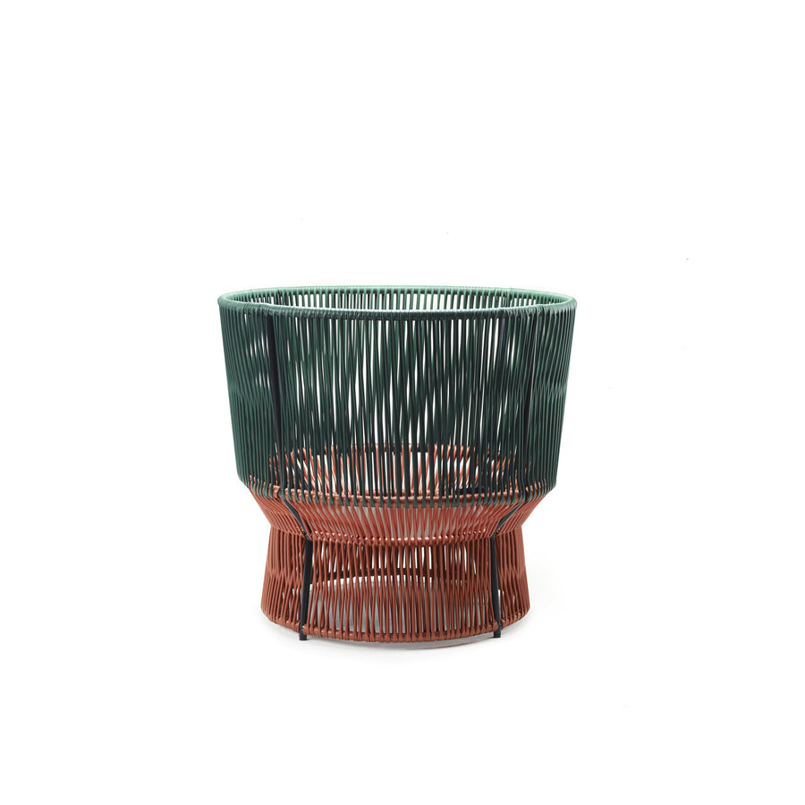 The Caribe Chic Basket 1 by Ames is a stylish wireframe chair crafted with the mamposino braiding technique using green and rust-colored metal rods. Its circular design offers a wide seat and slightly narrower base for an elegant, modern look.