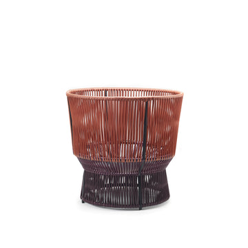 The Caribe Chic Basket 1 by Ames is a stylish, modern basket made using the mamposino braiding technique with red and dark brown recycled plastic strings. It features a striking two-tone design, open-top, and sturdy base for practicality and style.