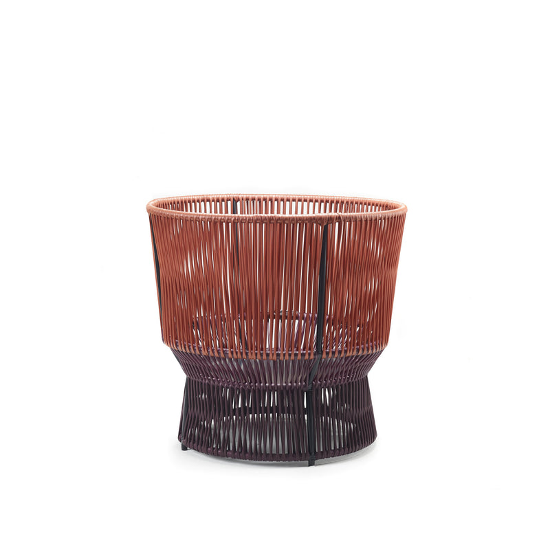 The Caribe Chic Basket 1 by Ames is a stylish, modern basket made using the mamposino braiding technique with red and dark brown recycled plastic strings. It features a striking two-tone design, open-top, and sturdy base for practicality and style.
