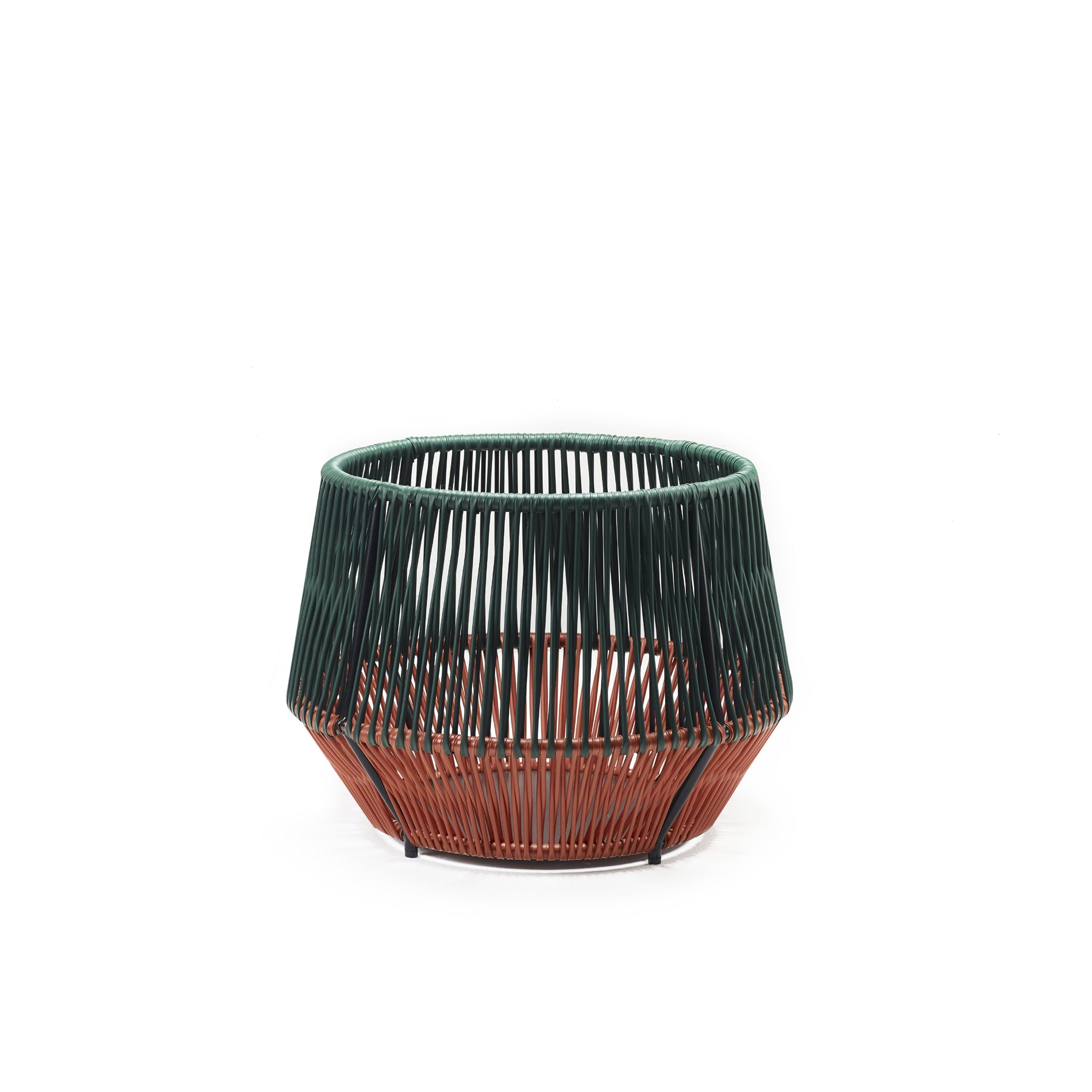 The Caribe Chic Basket 2 by Ames is a round, open-weave basket with a geometric design crafted using the mamposino braiding technique. Made from recycled plastic strings, its top half is dark green and the bottom is rust-colored, giving it a modern look against a white background.