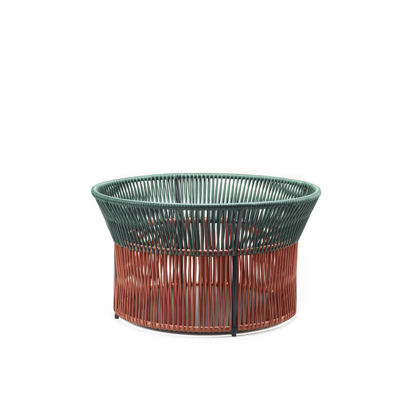 The Caribe Chic Basket 3 by Ames is a round, woven basket with a wide opening, featuring traditional braiding. The top is green and the bottom brown, showcasing modern design with the circular, open weave pattern that defines Chic Baskets.