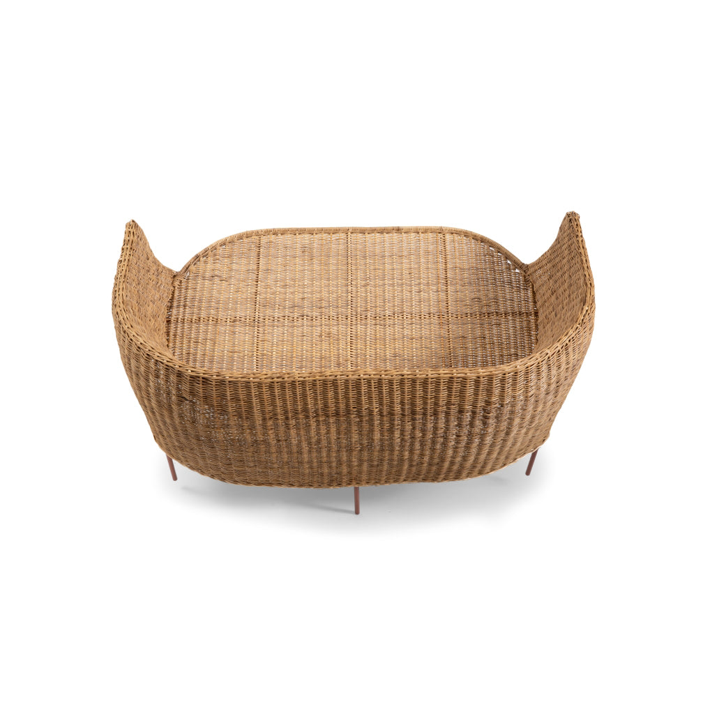 The Ames Caribe Natural Sofa boasts a rectangular, wicker basket design with high sides and an open top. It showcases Colombian craftsmanship with slightly curved corners and a woven texture, set against a white background.