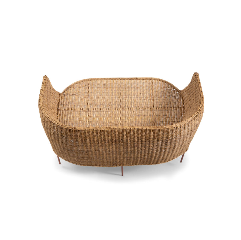 The Ames Caribe Natural Sofa boasts a rectangular, wicker basket design with high sides and an open top. It showcases Colombian craftsmanship with slightly curved corners and a woven texture, set against a white background.