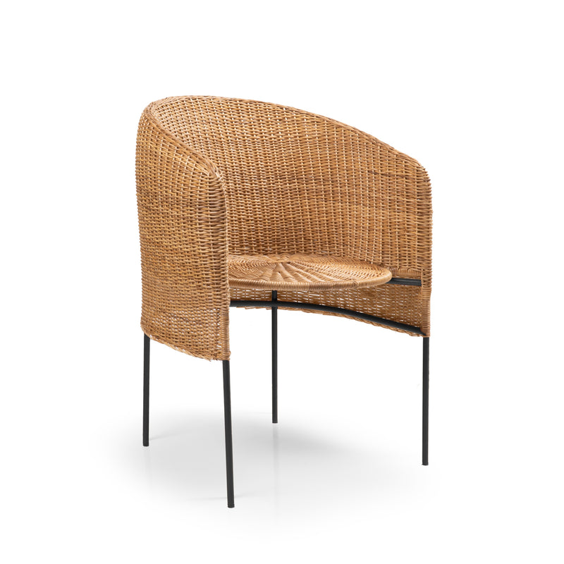 The Ames Caribe Natural Dining Chair by Ames features a round back, natural wicker woven seat, and black metal legs—highlighting Colombian craftsmanship. Photographed on a white background.