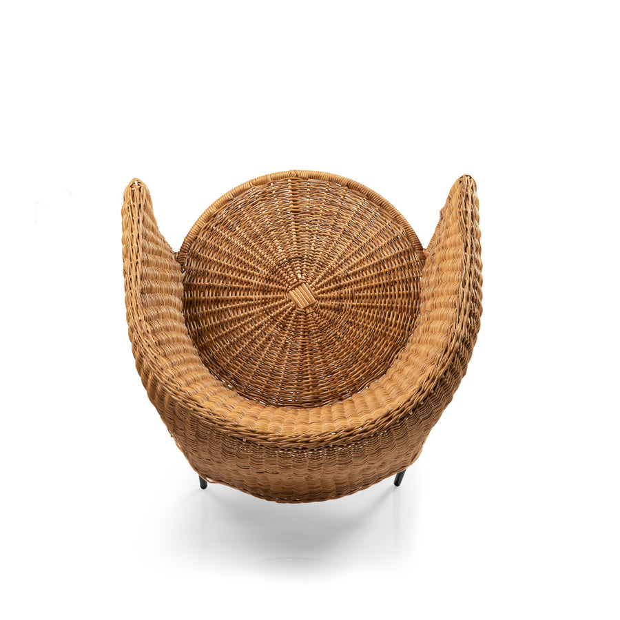 Top view of the Ames Caribe Natural Dining Chair by Ames, featuring a round, crescent-shaped, woven wicker design with high curved sides—an elegant showcase of Colombian craftsmanship in natural furniture.