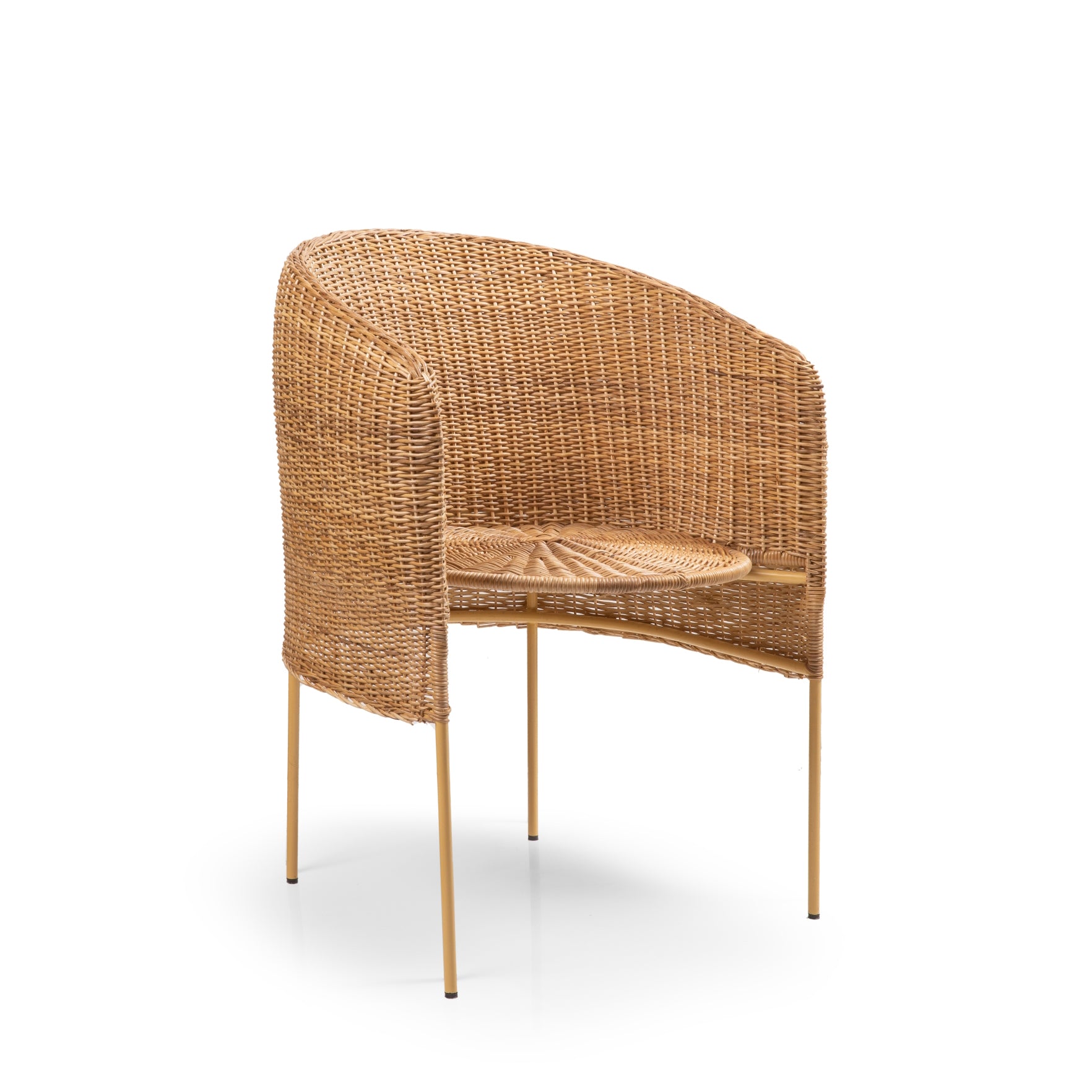 The Ames Caribe Natural Dining Chair by Ames showcases Colombian craftsmanship with a rounded backrest, armrests, woven rattan seat, and slim gold metal legs, set against a plain white background.