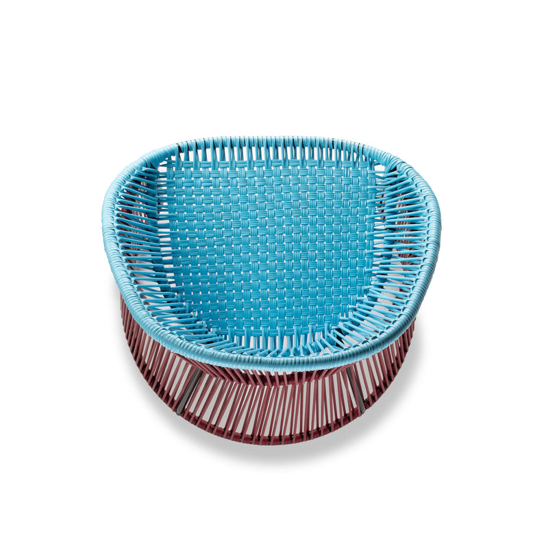 The Ames Cartagenas Dining Chair by Ames features a woven bright blue seat and backrest with maroon legs made of vertical rods. Its round shape adds a modern touch, making it a standout piece from the Cartagenas seating collection.