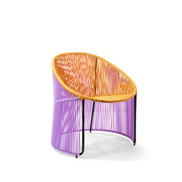 A vibrant addition to Ames Cartagenas collection, this modern lounge chair features a circular black frame. Tightly woven yellow cords form the seat and backrest, with purple cords on the sides and base, creating a striking contrast.