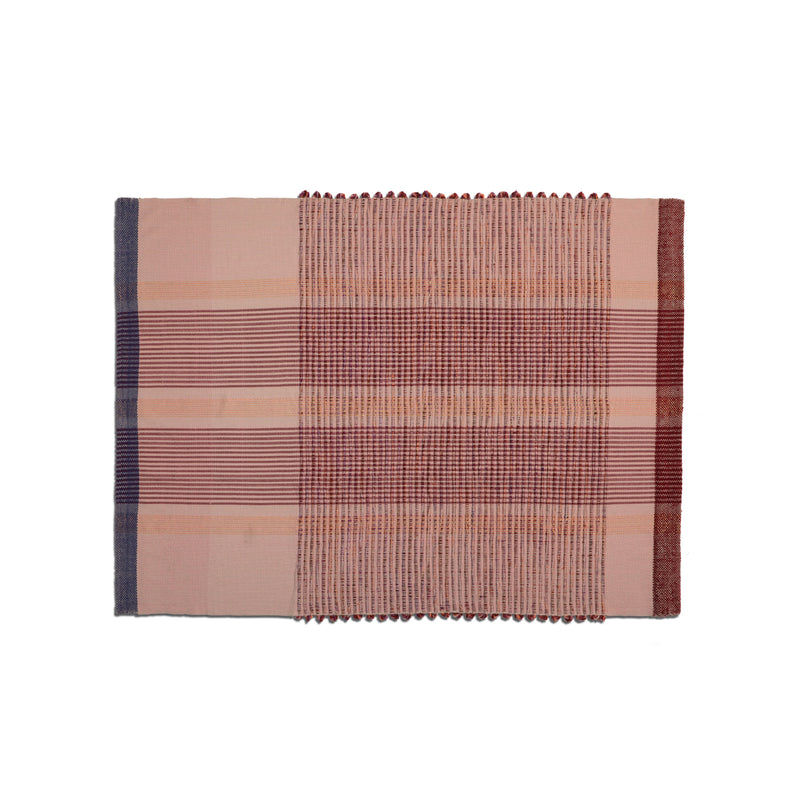 The Chumbes Throws by Ames showcase a rectangular woven textile with horizontal stripes in red, pink, and blue. The plaid pattern includes varying stripe widths and textured sections, reflecting Mae Engelgeers artistry.