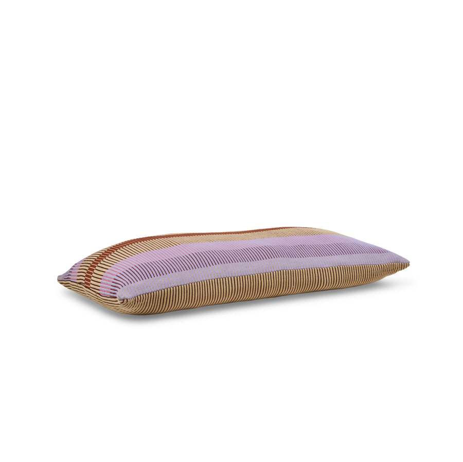 Introducing Ames Chumbes Layer: a rectangular, hand-woven cushion featuring horizontal stripes in purple, orange, and beige on a white background. This pillow stands out with its textured look and contrasting colors that reflect rich textile symbols.