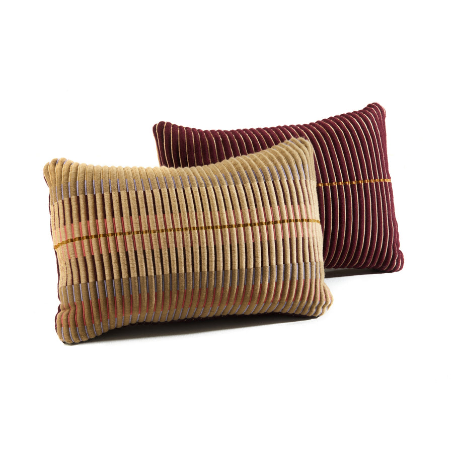 Two rectangular Ames Chumbes Cushions—one beige with multicolored stripes, the other burgundy with orange accents—are displayed on a white background. Both feature a corduroy texture and are from the Ames brand.