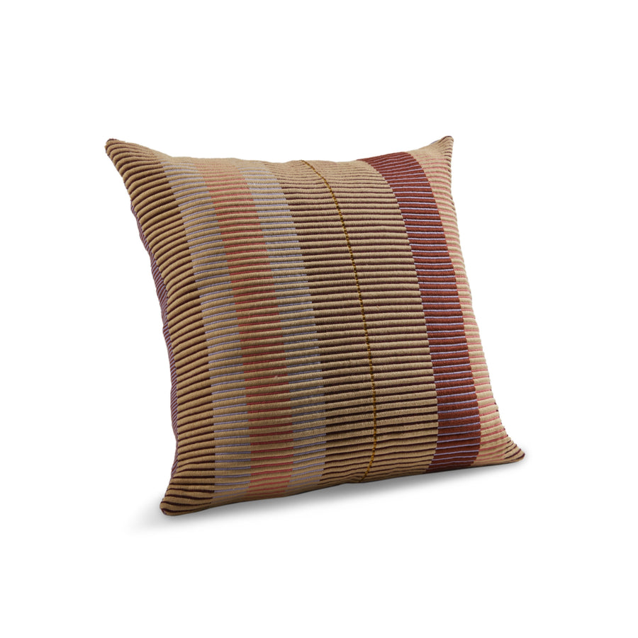 The Ames Chumbes Cushion by Ames is a square decorative pillow with a horizontal ribbed texture and stripes in beige, brown, gray, and reddish-burgundy, evoking Mae Engelgeer’s style on a white background.