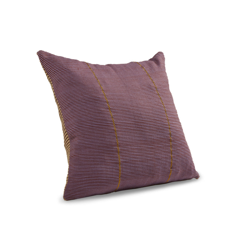 The Ames Chumbes Cushion by Ames, designed by Mae Engelgeer, is a square pillow with tightly spaced maroon and beige stripes plus two thin vertical gold lines, shown hand-woven against a white background.