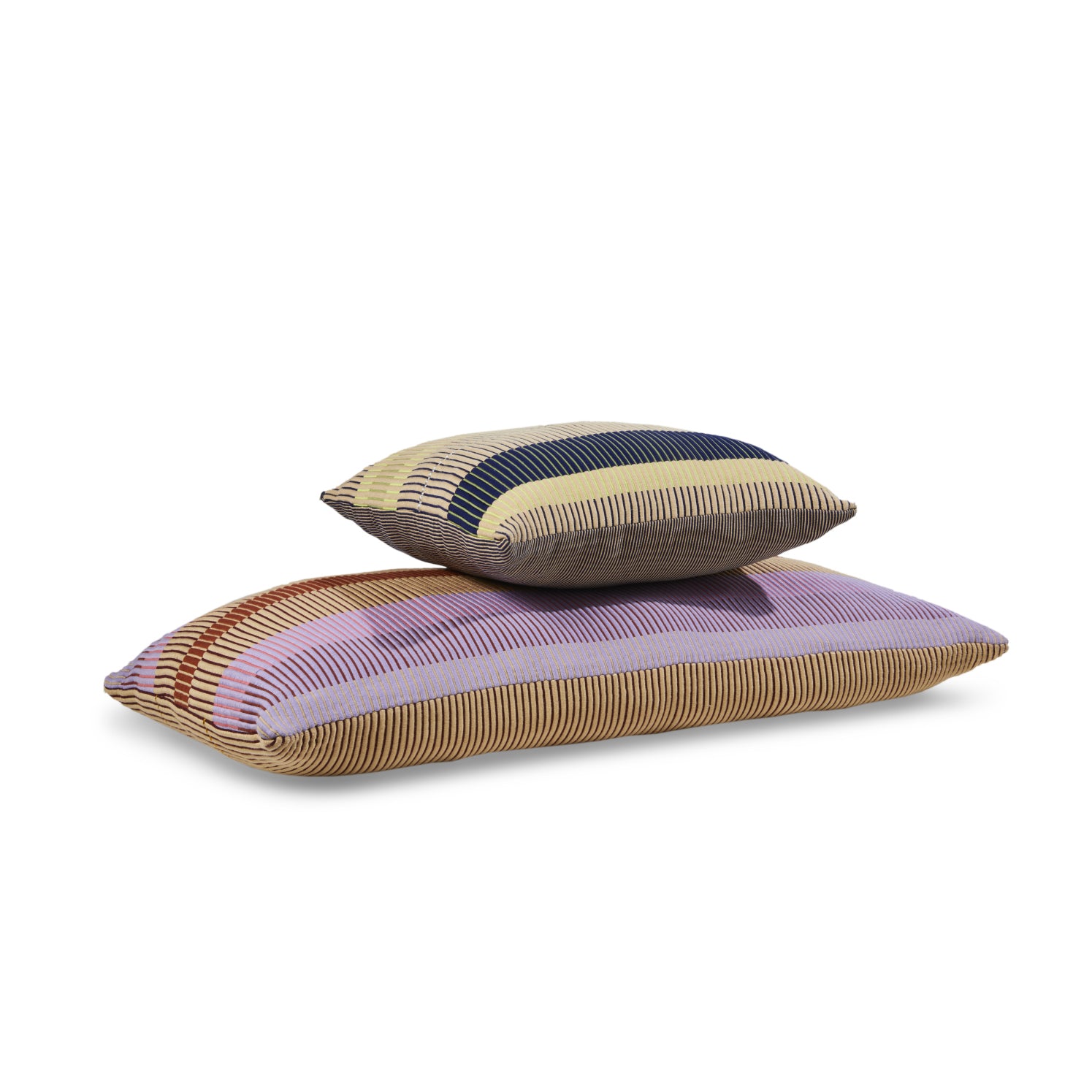 Two Chumbes Layer rectangular pillows by Ames are stacked, showcasing hand-woven striped patterns in purple, beige, blue, and brown. These cushions create a textured look with their varying colors against a plain white surface.